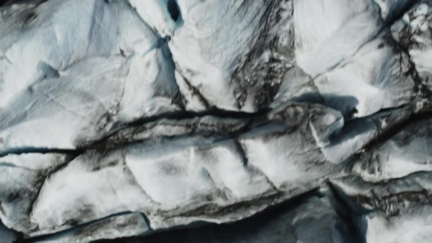 Arial view of melting cracked icebergs in the arctic