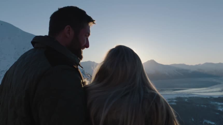 A man and woman talk together near a range