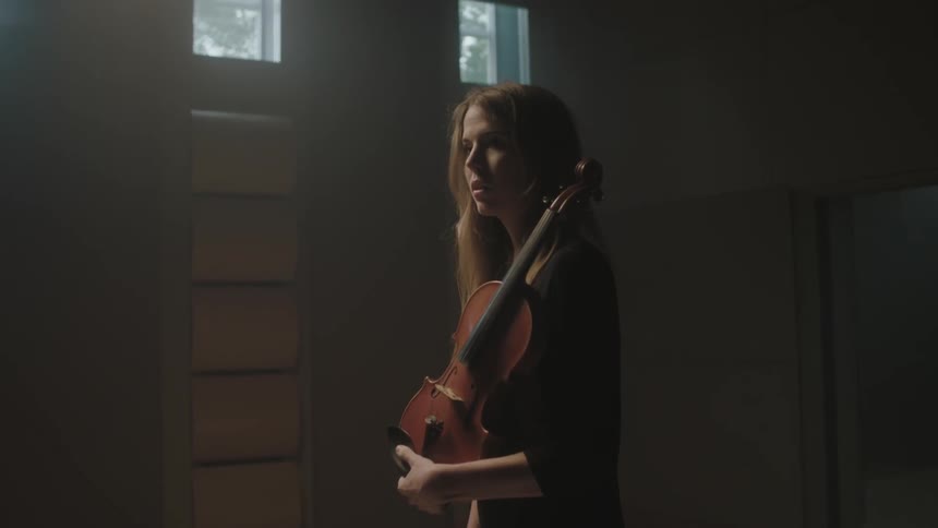 A woman is holding a violin
