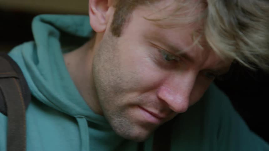 A man is standing in a room and working on something