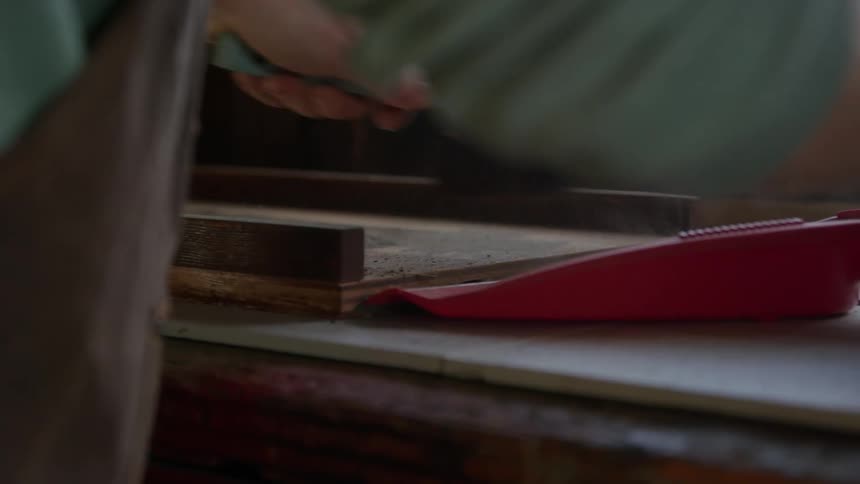 A man sweeping up dirt into a dustpan