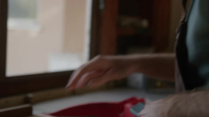 A man brushing dirt off a wooden board