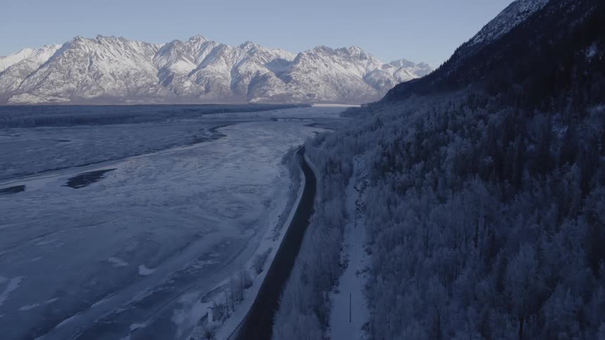 A road cuts through an icy area