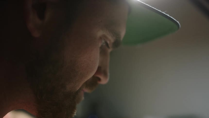 Close up view of a man wearing a hat is displayed