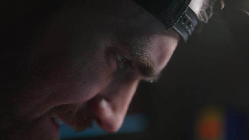 A man is looking down examining something