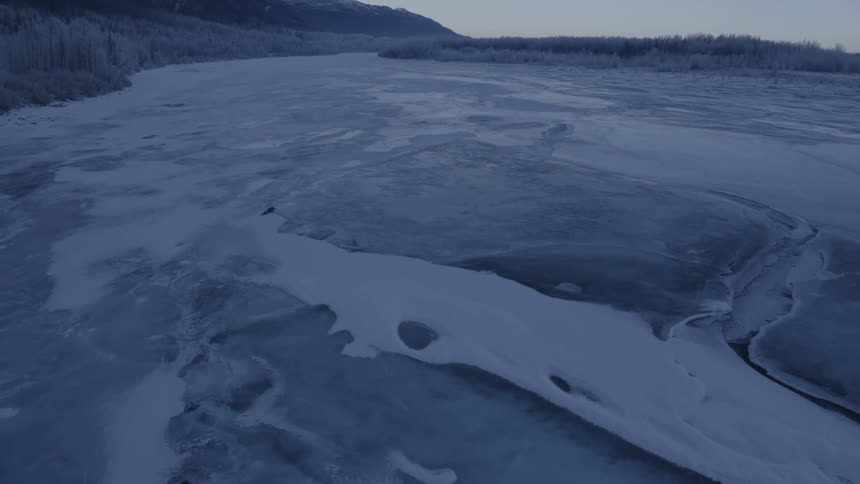 The entire landscape is frozen over on a cloudy day