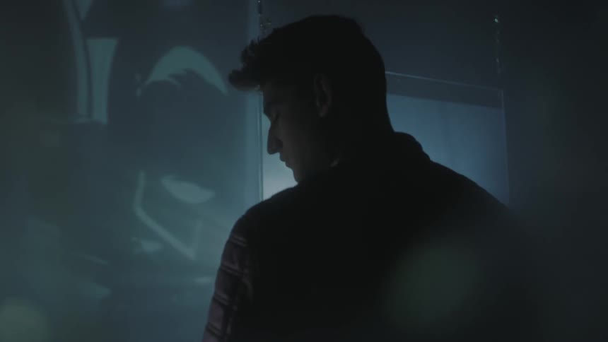 A man watches images flashed on a wall