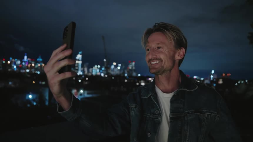A man is talking to someone on the phone while standing outdoors