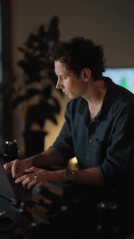 A man is typing on his laptop