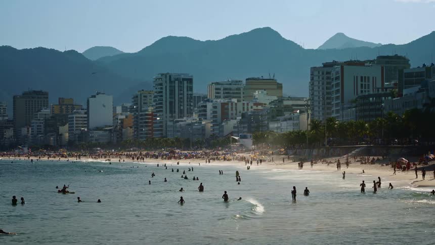 The beach by the city is full of people