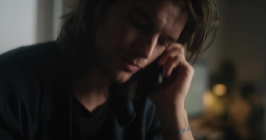 A man is on the phone and taking notes on a pad