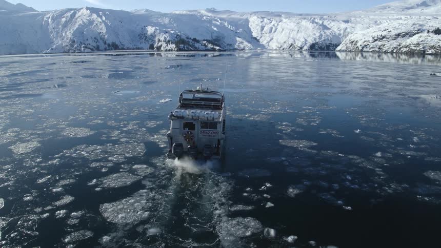 A boat travels in slushy water