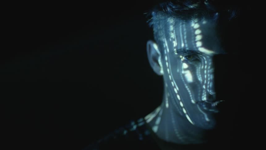 Lights flash on a man's face