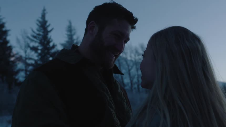 Man and woman happily gaze at each other in a winter afternoon
