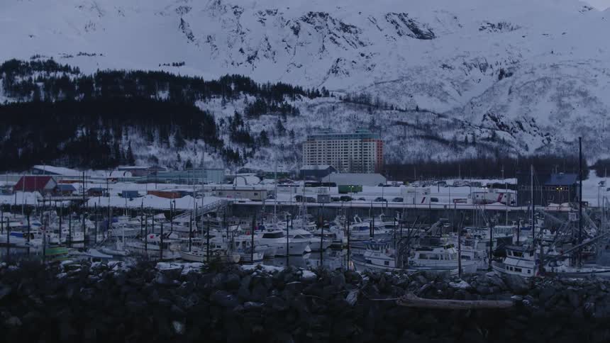 Boats are docked near the snow covered docks