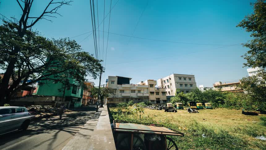 A time lapse of a residential neighborhood shows numerous bicyclists riding along a road