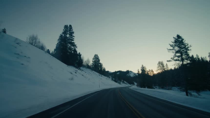 The sun is setting in the horizon of a rural area