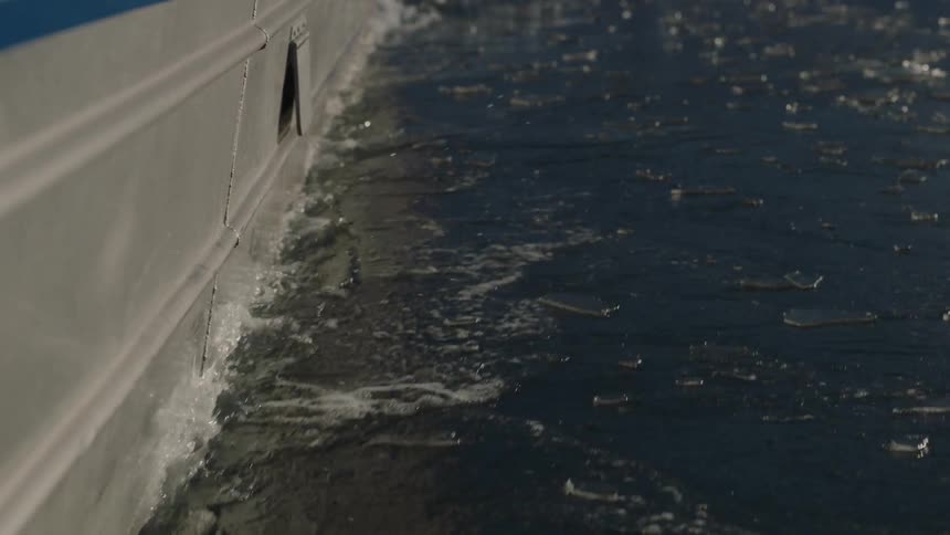 A boat pushes ice away as it sails