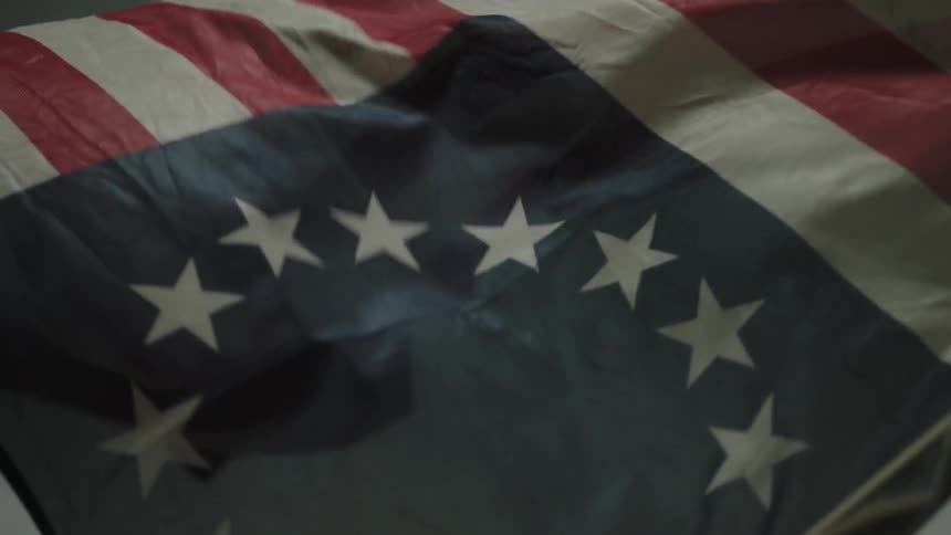 A colonial flag billows in the wind