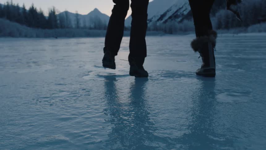 Two people are running over the ice