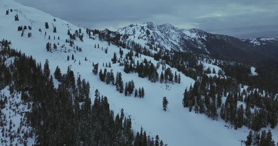 Aerial view of a snow covered mountain is displayed
