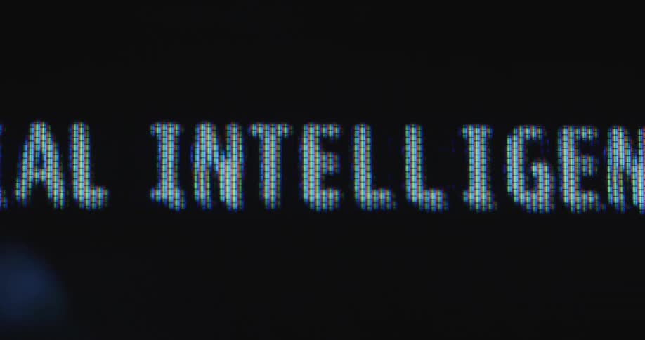 Close up of glitching digital letters spelling artificial intelligence moving across a dark retro screen with visible pixels