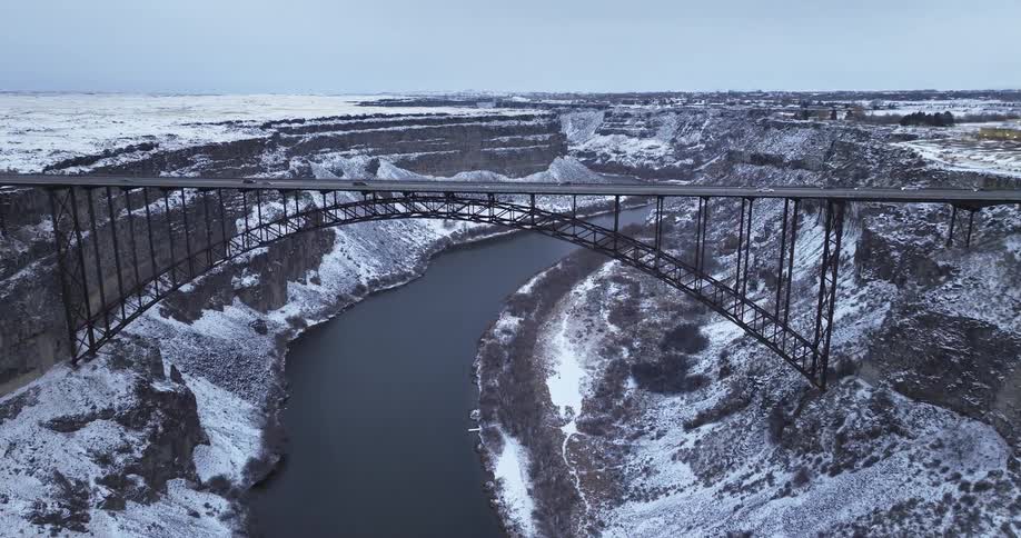 Cars are driving over a bridge during the winter season