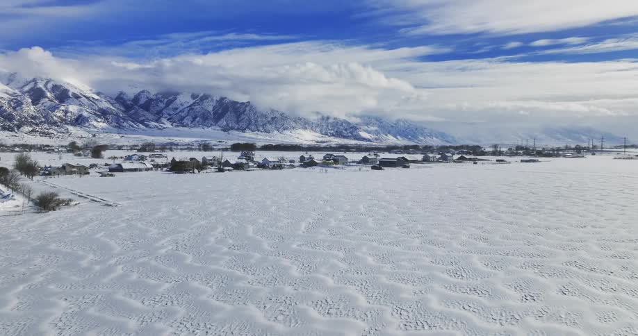 A view of a landscape with houses in winter is displayed