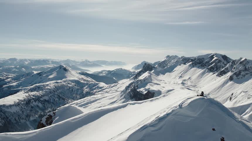 Aerial view of mountaineer on snowy mountain on a cloudy day