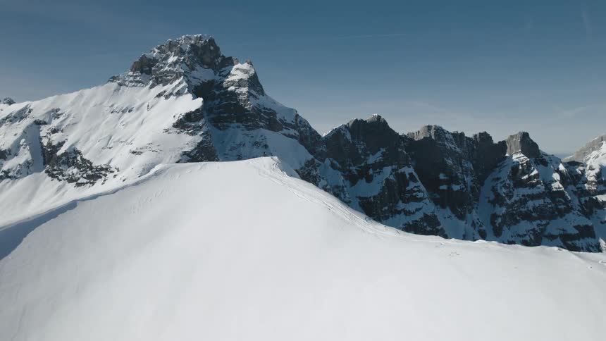 A snowy mountain range in the wilderness on a clear winter day