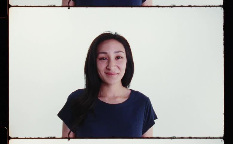 A woman smiles in the film slide