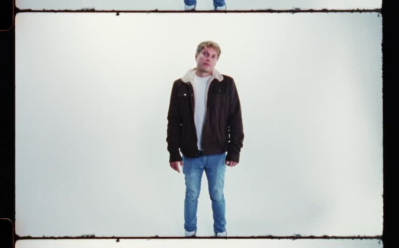 A portrait of a man posing for the camera is displayed