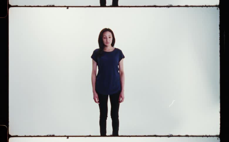 A woman is standing and posing for the camera