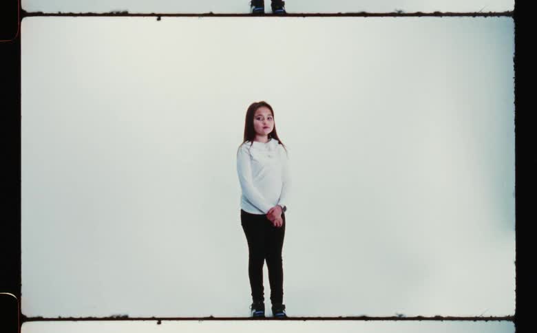 A woman is posing and turning to the side