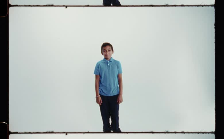 Youth smiles while standing and posing