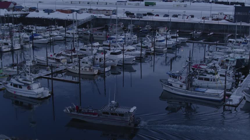 A boat is sailing near the docks