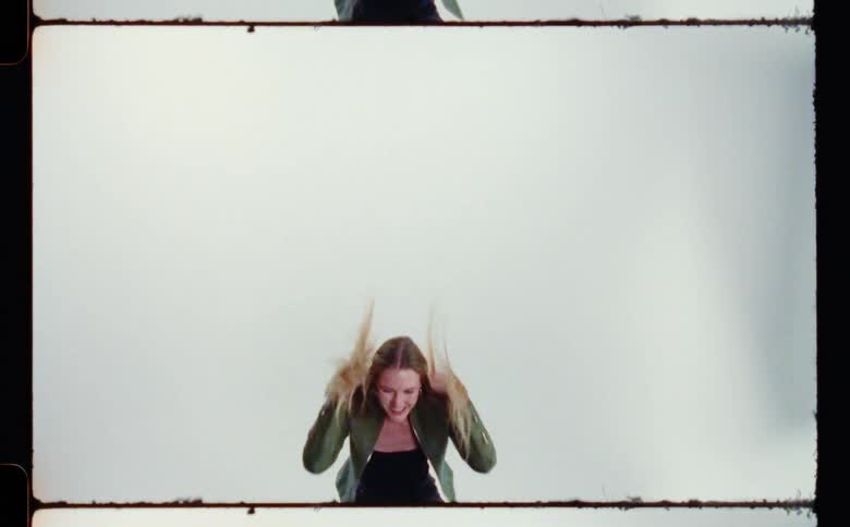 A woman is posing and moving around