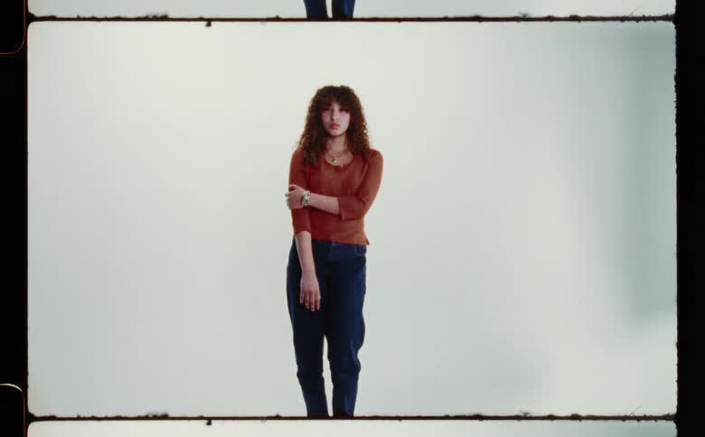 Portrait of a woman standing near a wall