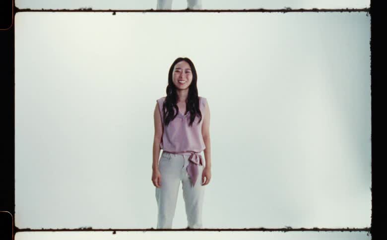 A woman smiles as she poses