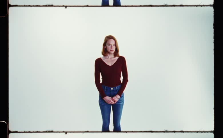 A woman is standing for the portrait on film