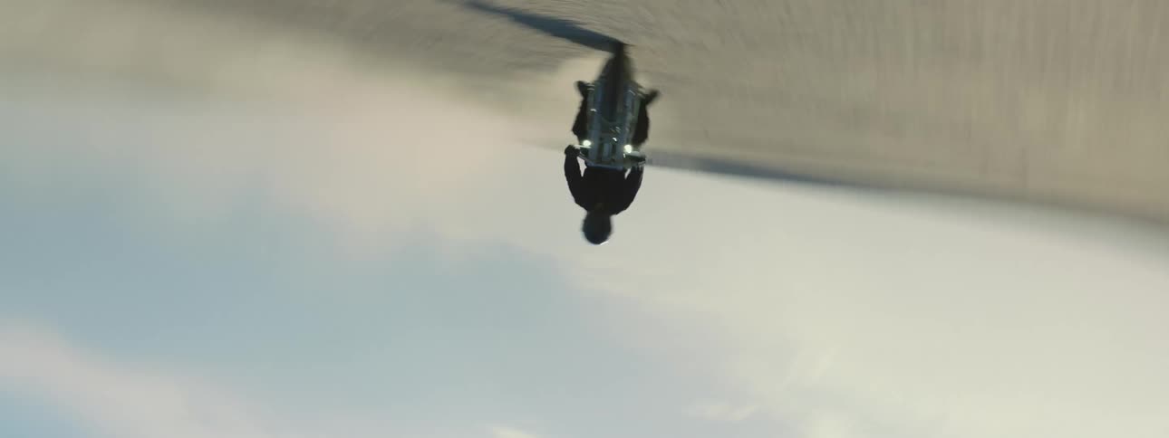 A person riding a motorcycle across a dirt field
