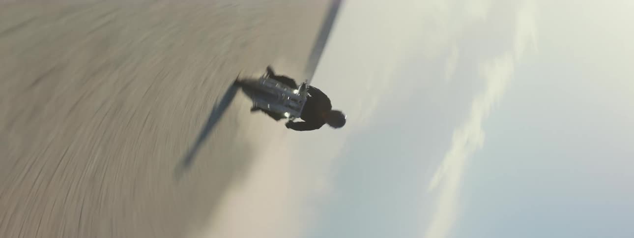 A person is filmed driving their motorcycle outdoors