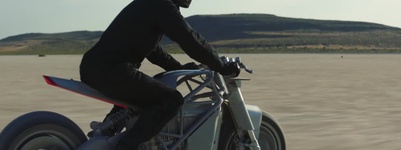 Person is riding their motorcycle outdoors in the wilderness