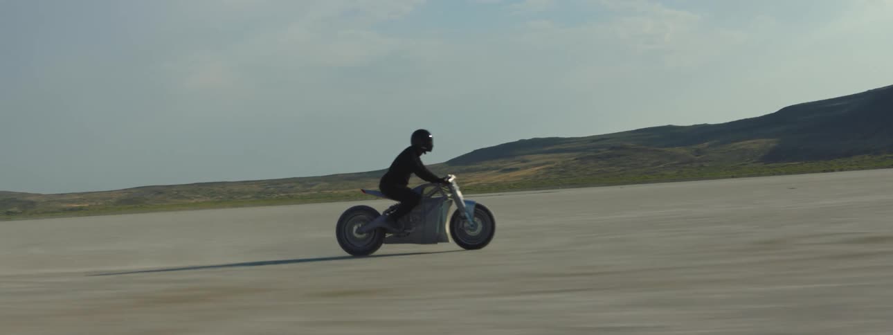 A person races through the desert on a motorcycle