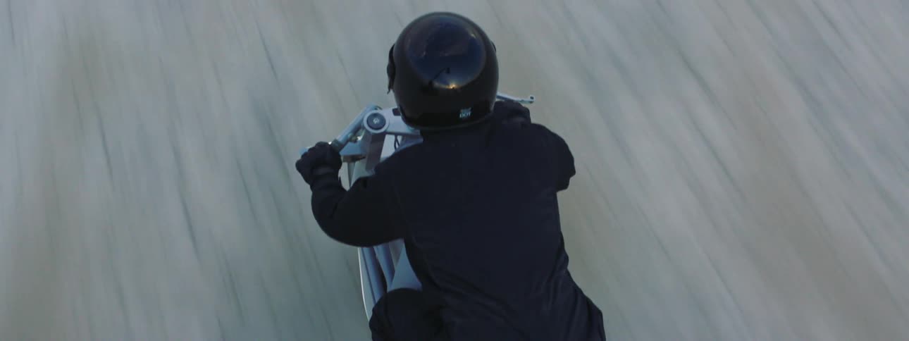 A person is riding their motorcycle outdoors at midday