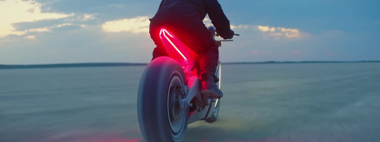 A person is riding their motorcycle through a rural area