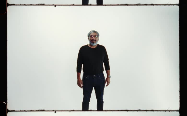 Man standing wearing black pants and shirt smiling at camera