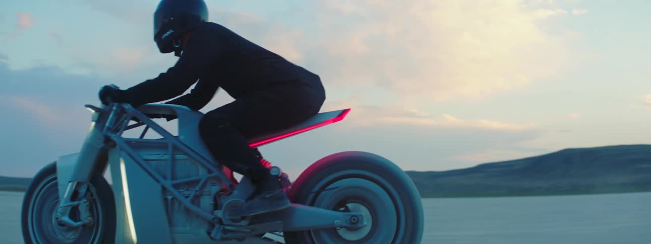 A person is riding a motorcycle in the desert
