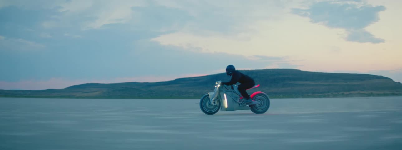 A person is riding a motorcycle in the desert