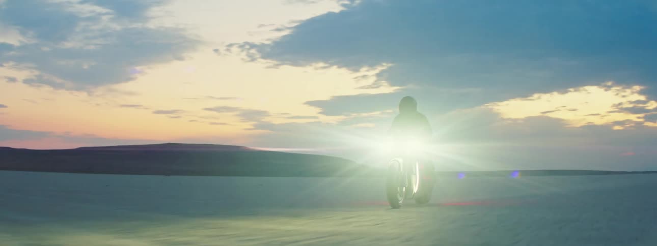 The motorcycle headlight shines in the desert
